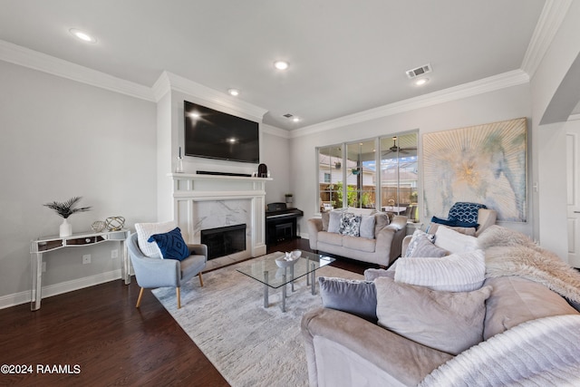 living room with a premium fireplace, hardwood / wood-style floors, and ornamental molding