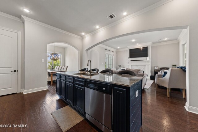 kitchen with crown molding, dark stone counters, dishwasher, dark wood-type flooring, and sink