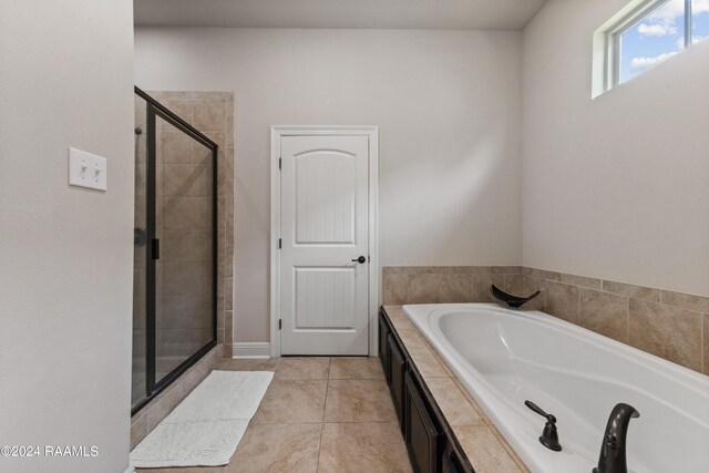 bathroom featuring plus walk in shower and tile patterned floors