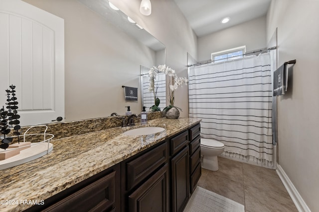 bathroom with vanity, tile patterned flooring, and toilet