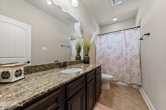 bathroom featuring vanity, tile patterned flooring, and toilet