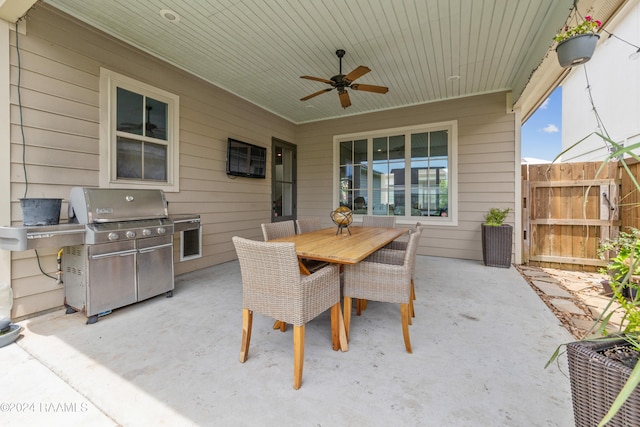 view of patio / terrace with ceiling fan, a grill, and an outdoor kitchen