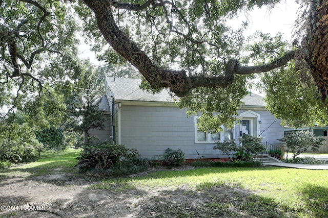 obstructed view of property featuring a front lawn