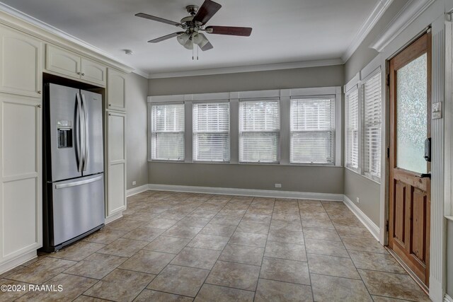 interior space with light tile patterned floors, crown molding, ceiling fan, and stainless steel refrigerator with ice dispenser