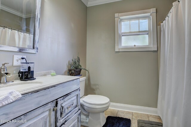 bathroom featuring vanity, crown molding, tile patterned floors, and toilet