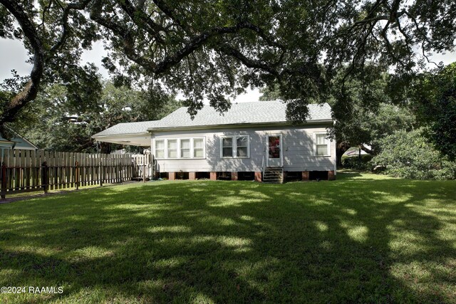 back of property featuring a yard