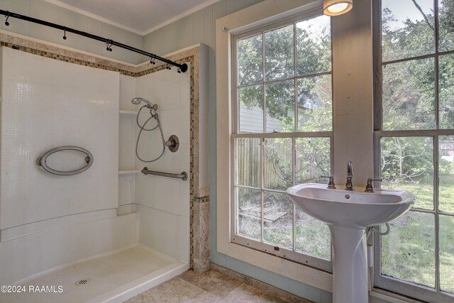 bathroom with walk in shower, tile patterned floors, and sink