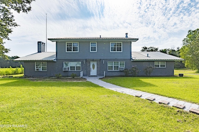 view of front of home featuring a front yard and cooling unit