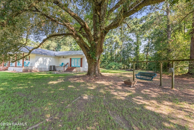 view of yard featuring central AC and a jacuzzi