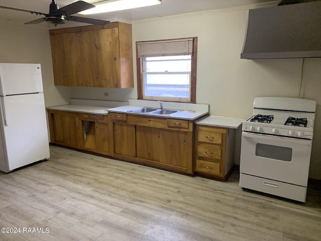 kitchen featuring sink, light wood-type flooring, ornamental molding, white appliances, and wall chimney range hood