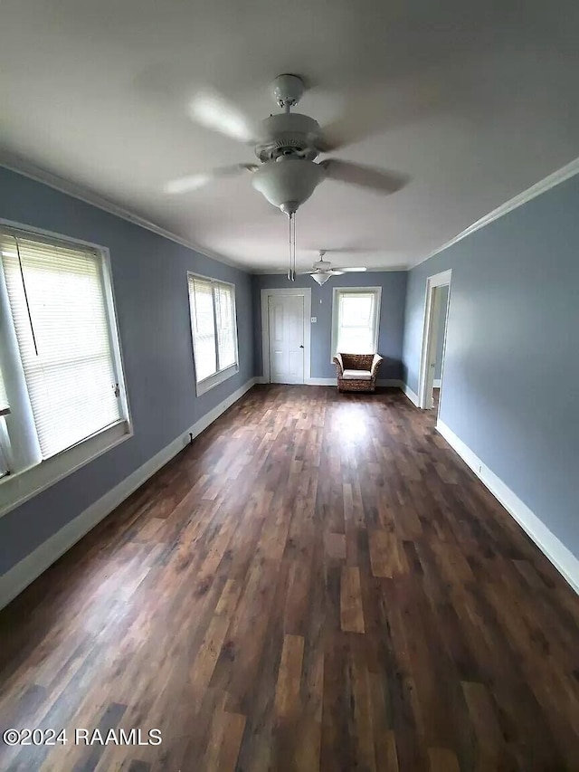 empty room featuring crown molding and dark hardwood / wood-style floors