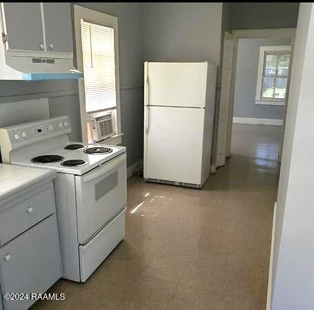 kitchen with cooling unit, white appliances, and white cabinets