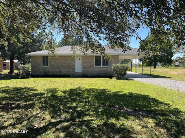 single story home featuring a front lawn and a carport