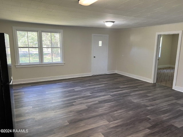 unfurnished room featuring dark wood-type flooring