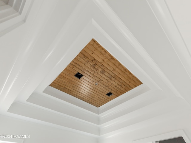 details featuring wood ceiling and a raised ceiling