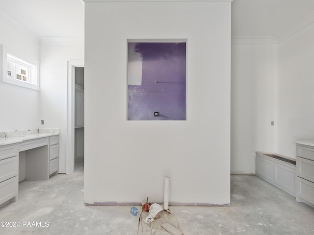 bedroom with built in desk and crown molding