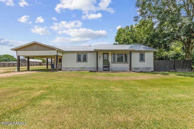 view of front of house with a carport and a front lawn