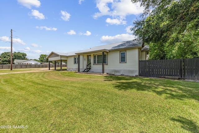 rear view of property with a yard