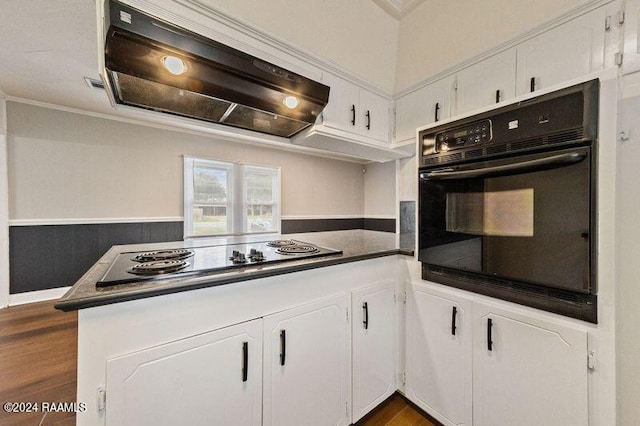 kitchen featuring dark wood-type flooring, premium range hood, black appliances, white cabinets, and kitchen peninsula