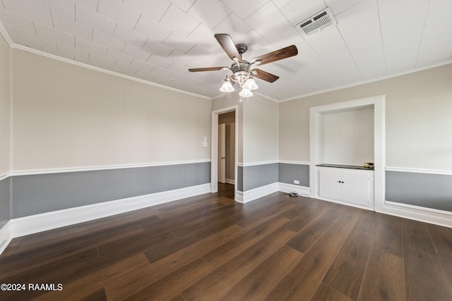 empty room with crown molding, ceiling fan, and dark hardwood / wood-style flooring