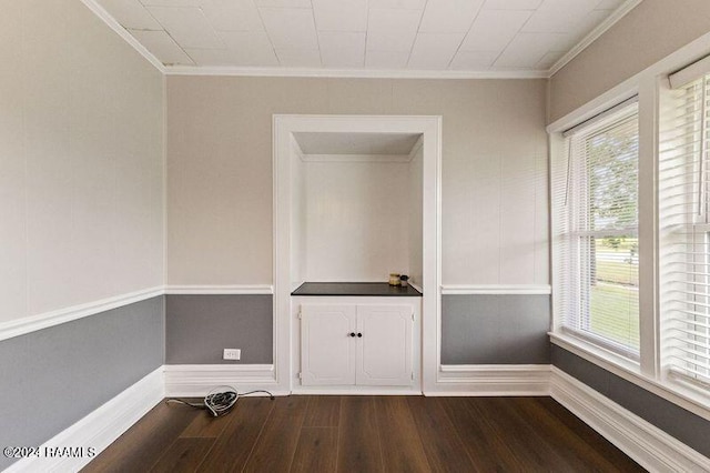 empty room featuring crown molding and hardwood / wood-style floors