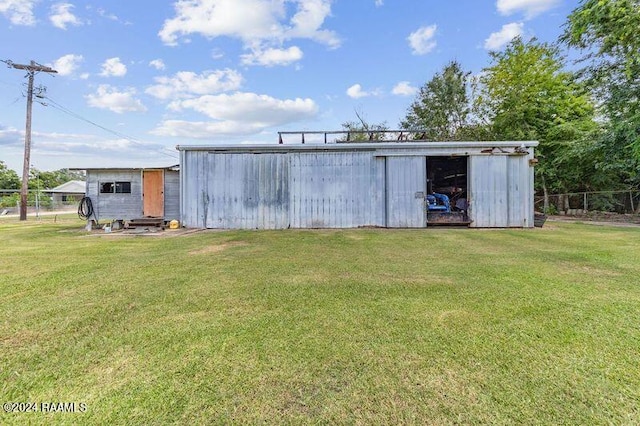 view of outbuilding featuring a lawn