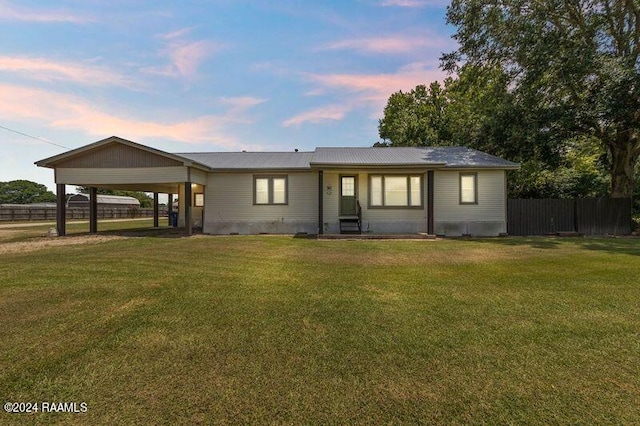 exterior space with a carport and a yard