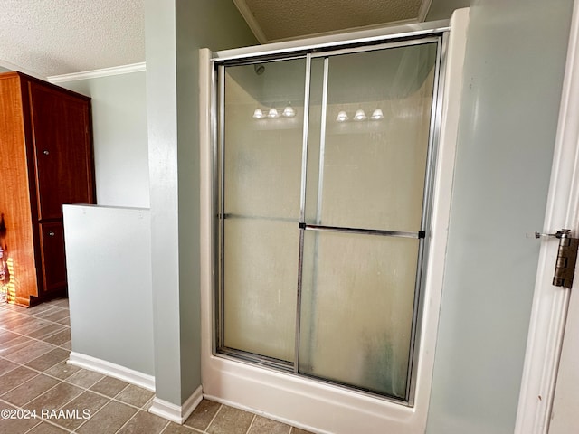 bathroom featuring crown molding, a textured ceiling, walk in shower, and tile patterned flooring