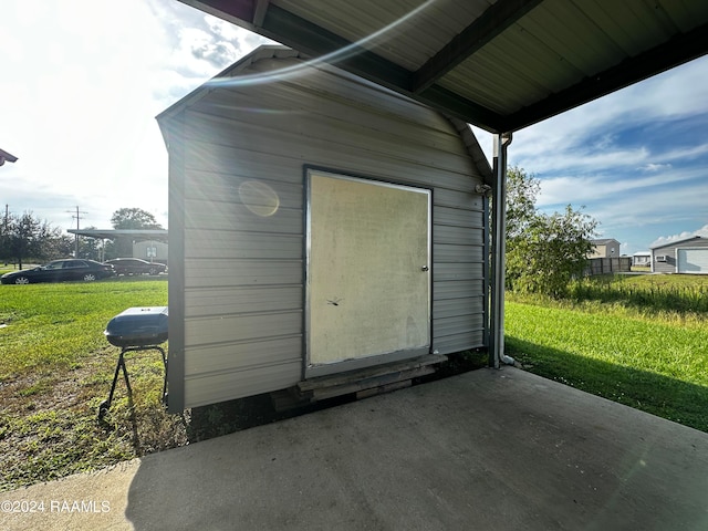 view of outbuilding featuring a lawn