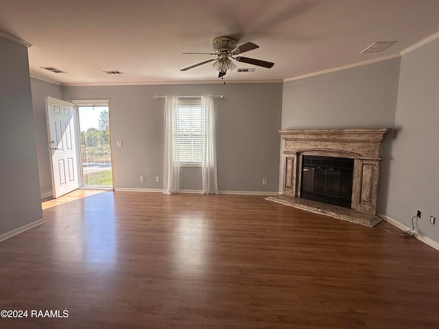 unfurnished living room featuring dark wood-type flooring, ceiling fan, and ornamental molding