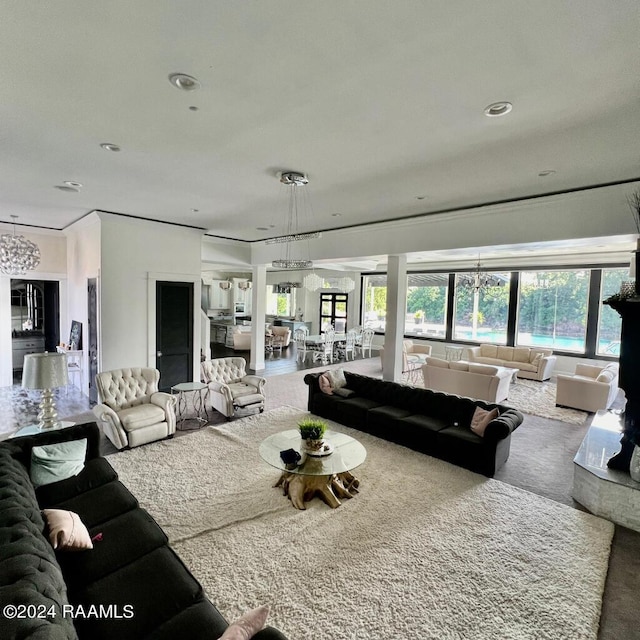 living room with recessed lighting and an inviting chandelier