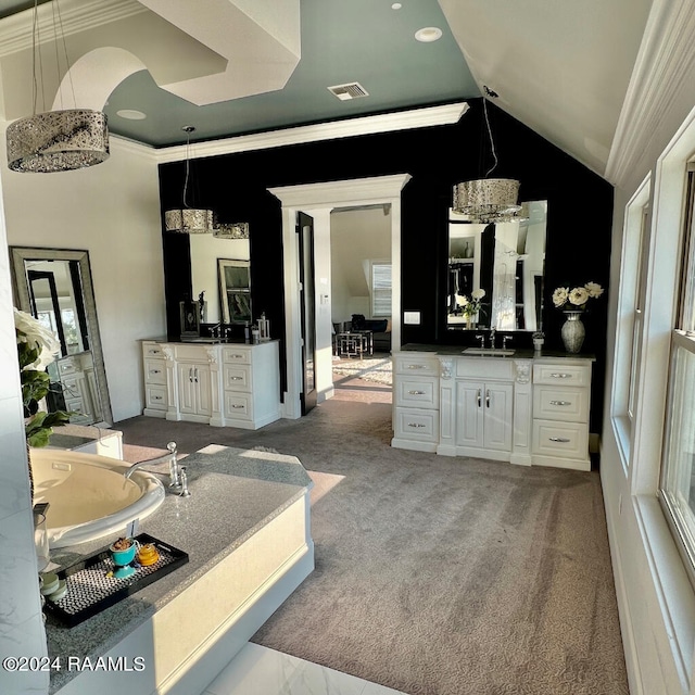 interior space with vanity, high vaulted ceiling, crown molding, and a bathing tub