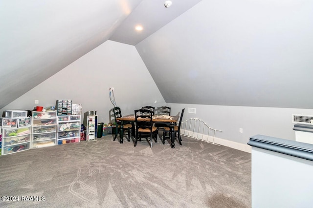 interior space featuring carpet floors and vaulted ceiling