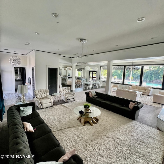 carpeted living room with a chandelier