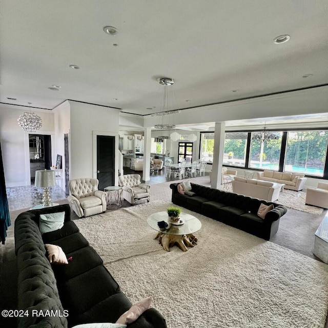 living room featuring recessed lighting and a notable chandelier