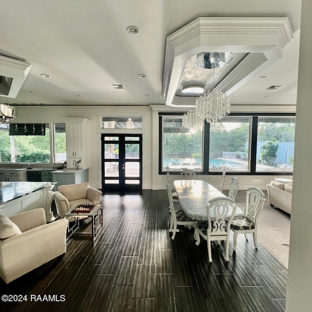 dining space with french doors, a notable chandelier, and a healthy amount of sunlight