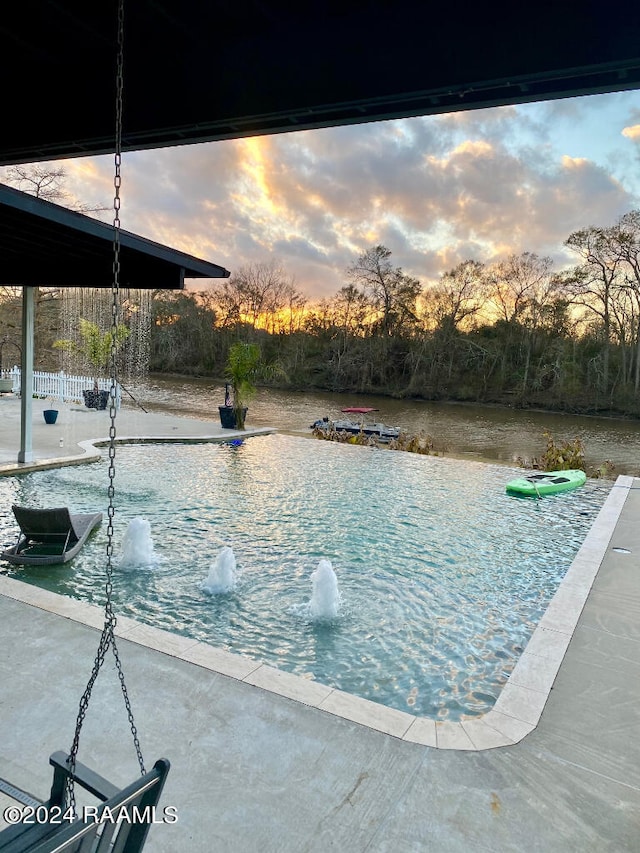 view of pool at dusk