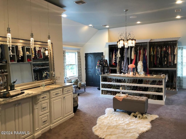 interior space featuring lofted ceiling, light stone counters, carpet, and visible vents