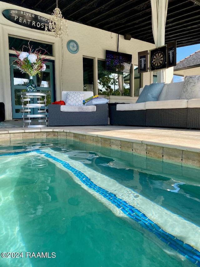 view of swimming pool featuring an outdoor living space