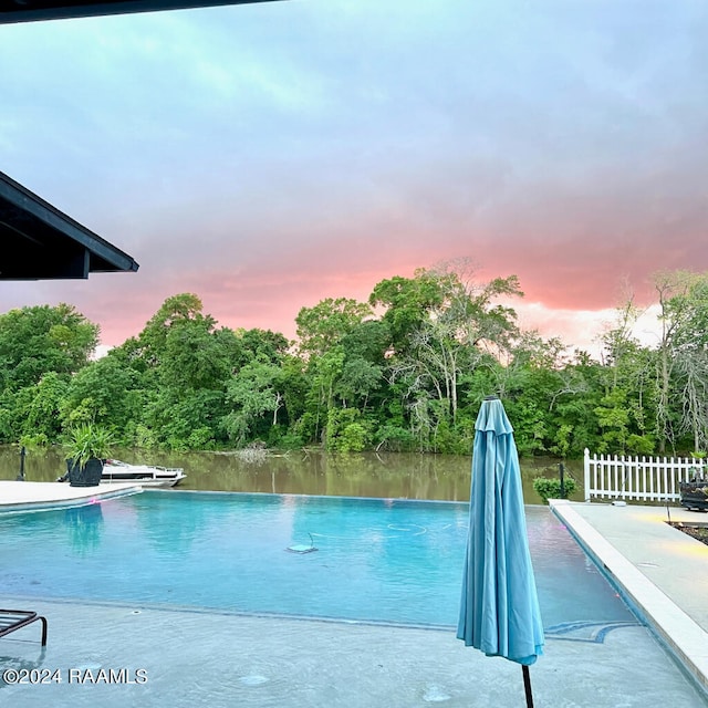 view of pool at dusk