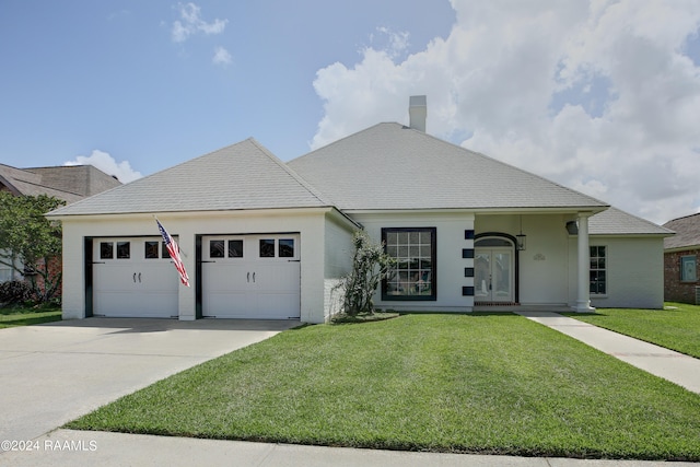 view of front of home with a garage and a front yard