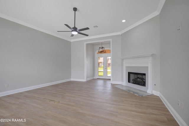 unfurnished living room with ceiling fan, crown molding, french doors, and light hardwood / wood-style flooring