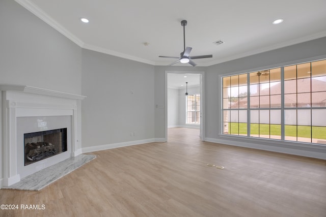 unfurnished living room with crown molding, light wood-type flooring, and ceiling fan