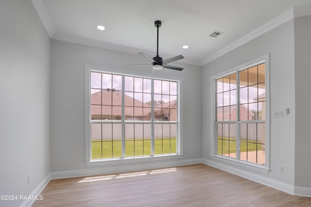 empty room with ornamental molding, ceiling fan, and light wood-type flooring