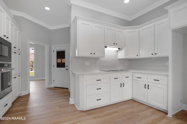 kitchen featuring decorative backsplash, crown molding, black appliances, and light hardwood / wood-style flooring