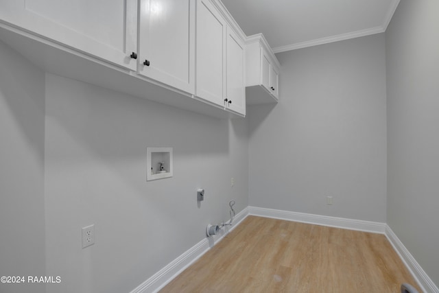 laundry room with gas dryer hookup, electric dryer hookup, cabinets, light hardwood / wood-style flooring, and washer hookup