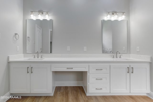 bathroom with wood-type flooring and double sink vanity