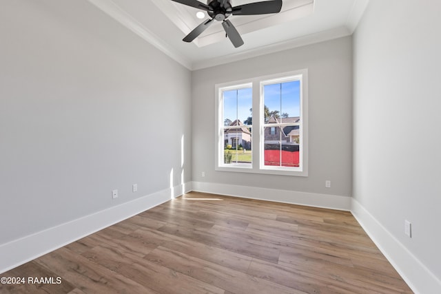 empty room with light hardwood / wood-style flooring, ornamental molding, and ceiling fan