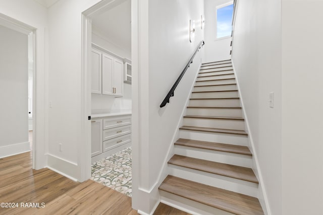 staircase with hardwood / wood-style flooring