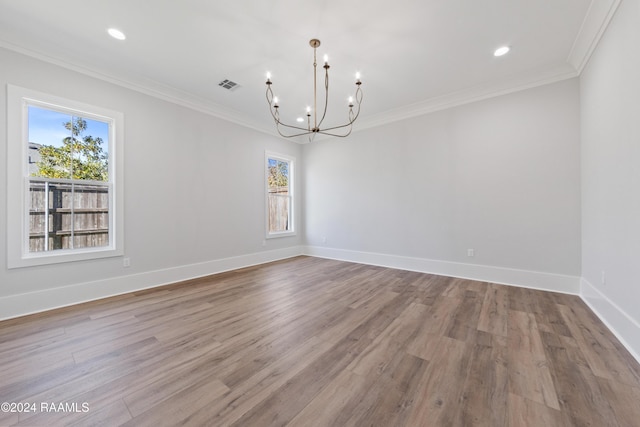 unfurnished dining area featuring crown molding, a notable chandelier, light hardwood / wood-style floors, and a wealth of natural light